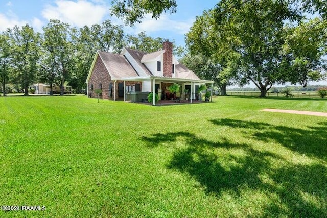 rear view of property featuring a yard