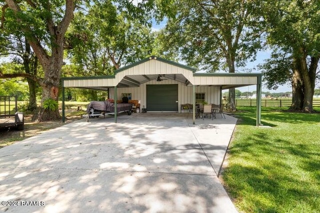 exterior space featuring a garage, a lawn, and a carport