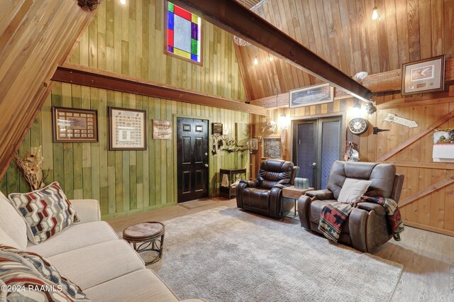 living room featuring wooden ceiling, beamed ceiling, high vaulted ceiling, hardwood / wood-style floors, and wooden walls