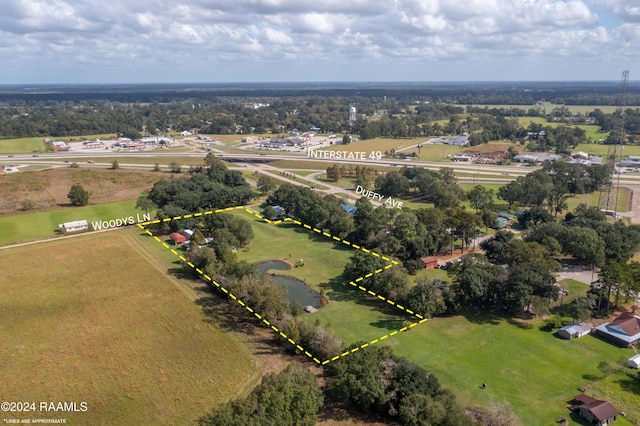 135 Woodys Ln, Sunset, LA 70584 - aerial overview of property's location with property boundaries highlighted and a tree filled landscape