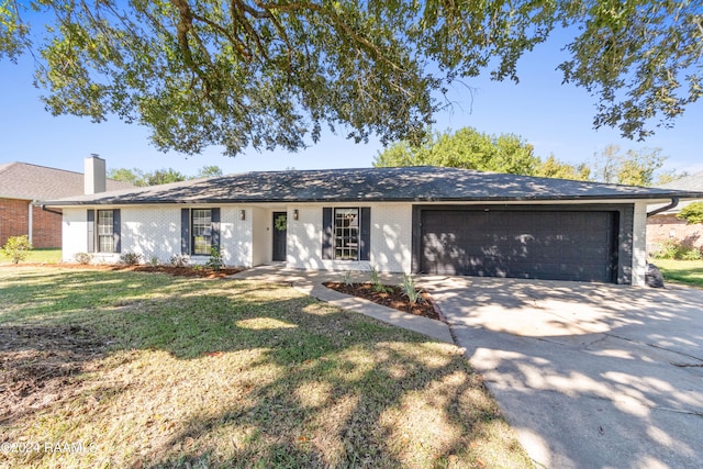 ranch-style house featuring a front yard and a garage