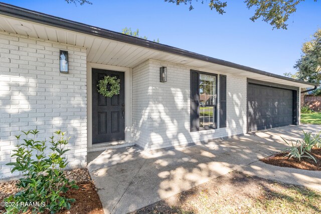 doorway to property with a garage