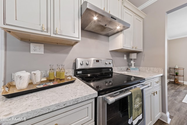 kitchen featuring ornamental molding, white cabinets, electric stove, and dark hardwood / wood-style flooring