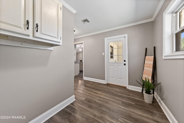 interior space with ornamental molding and dark hardwood / wood-style floors