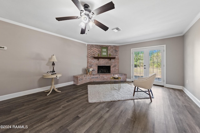 living room with ceiling fan, crown molding, dark hardwood / wood-style flooring, a fireplace, and french doors