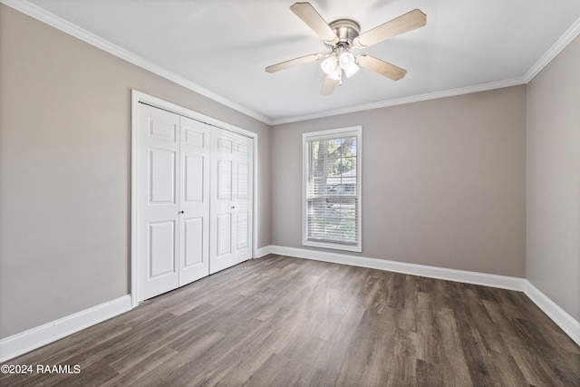 unfurnished bedroom with crown molding, ceiling fan, a closet, and dark hardwood / wood-style floors