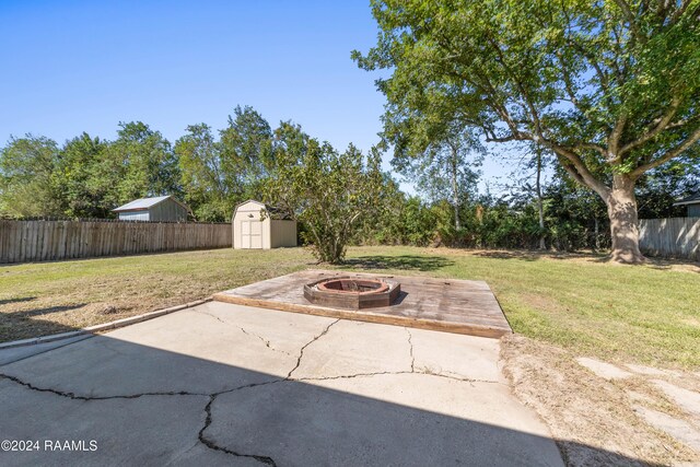 view of patio / terrace featuring a shed and a fire pit