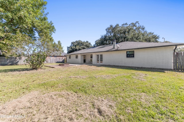 back of property featuring a yard and a patio area