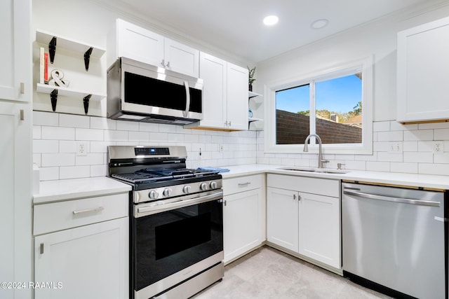 kitchen featuring white cabinetry, sink, and appliances with stainless steel finishes