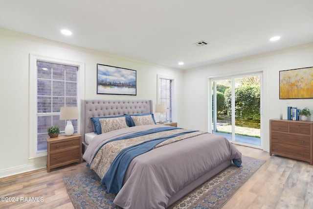 bedroom featuring light hardwood / wood-style floors, ornamental molding, and access to outside