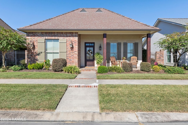 bungalow-style house with a front lawn and a porch