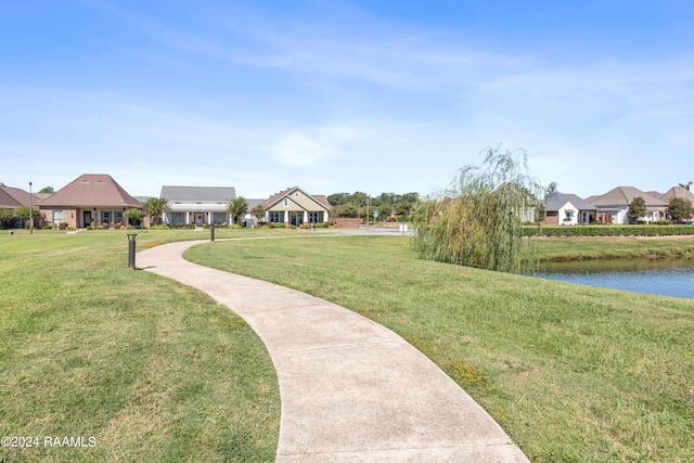 view of property's community featuring a yard and a water view