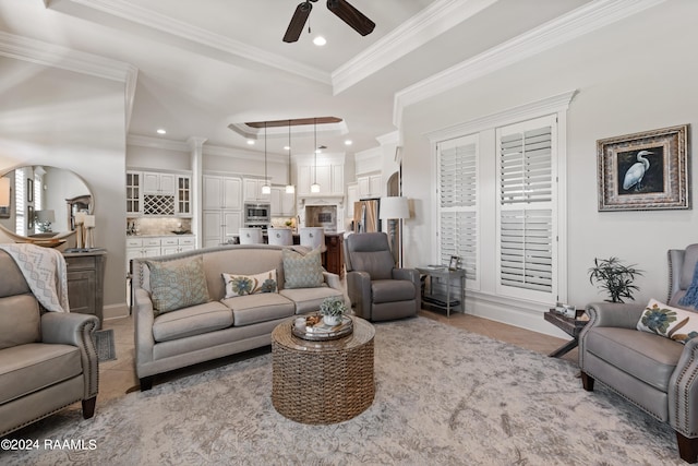 living room featuring ornamental molding, ceiling fan, and light tile patterned floors