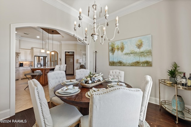 dining room with a notable chandelier, ornamental molding, sink, and dark hardwood / wood-style floors