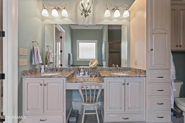 bathroom with vanity, toilet, and a shower with door