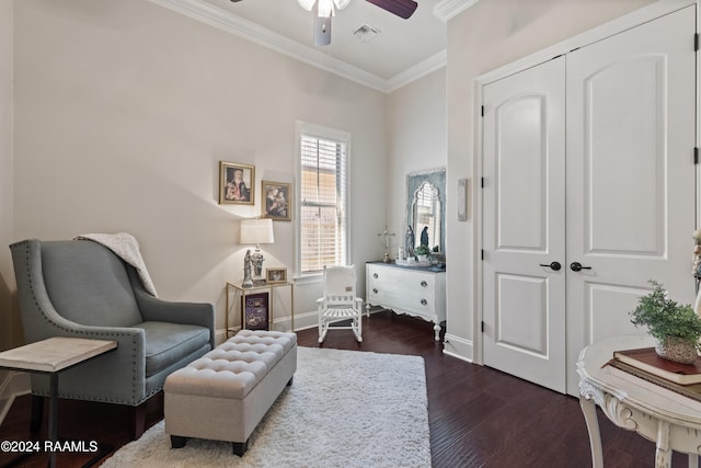 sitting room featuring ceiling fan, ornamental molding, and dark hardwood / wood-style floors