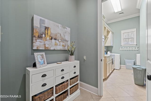 hall featuring crown molding, light tile patterned floors, and washer / clothes dryer