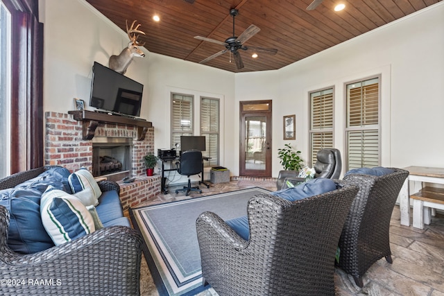 view of patio featuring an outdoor brick fireplace and ceiling fan