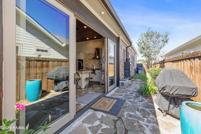 view of patio featuring area for grilling and central AC