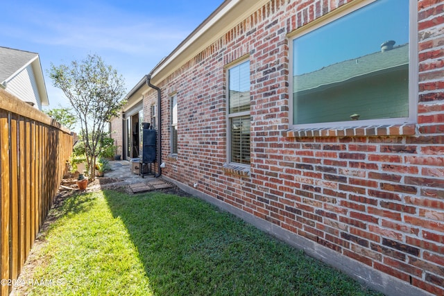 view of side of home featuring a yard