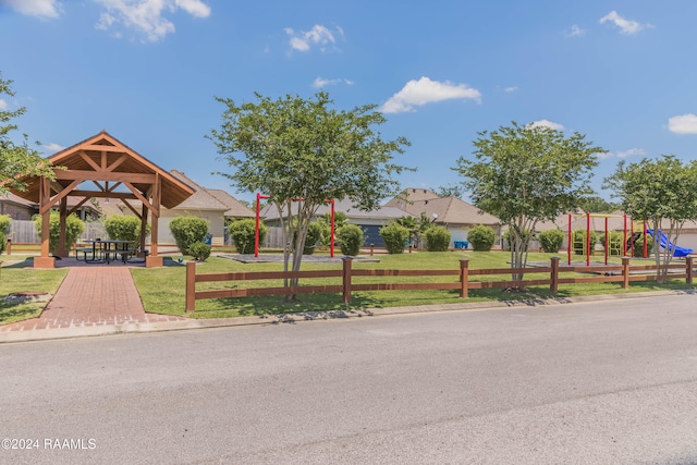 surrounding community with a gazebo, a lawn, and a playground