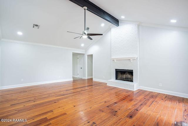 unfurnished living room featuring hardwood / wood-style floors, vaulted ceiling with beams, and crown molding