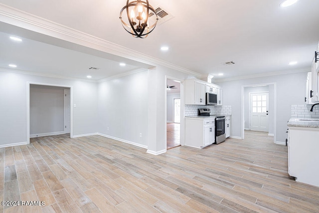 kitchen featuring tasteful backsplash, light wood-type flooring, white cabinets, and stainless steel appliances