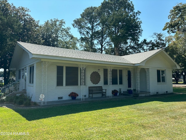 ranch-style home with a porch and a front lawn