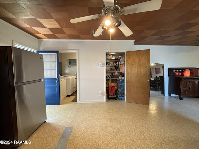 kitchen with ceiling fan, stainless steel refrigerator, and washing machine and clothes dryer