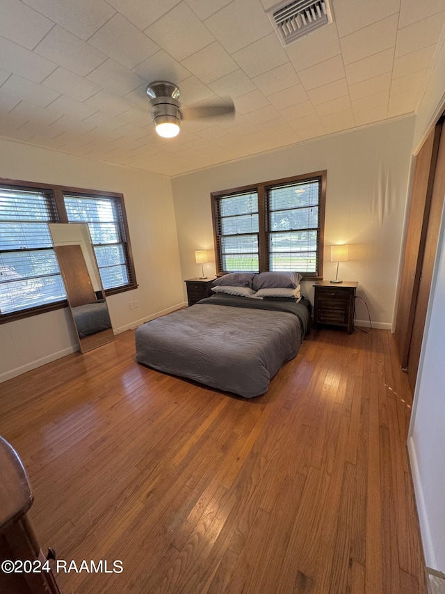 bedroom with wood-type flooring and ceiling fan