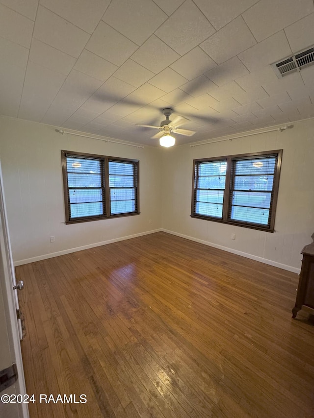 empty room featuring ornamental molding, hardwood / wood-style flooring, and ceiling fan