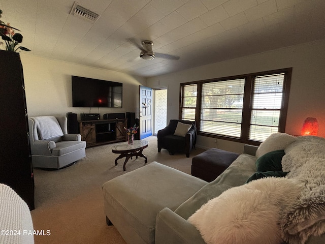 carpeted living room featuring ceiling fan