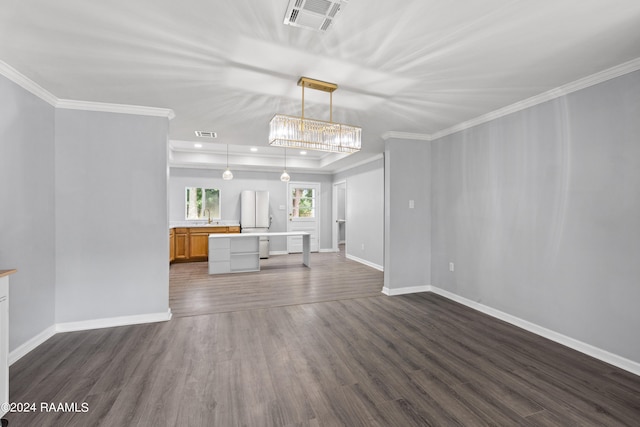 unfurnished living room featuring dark hardwood / wood-style floors, crown molding, and sink