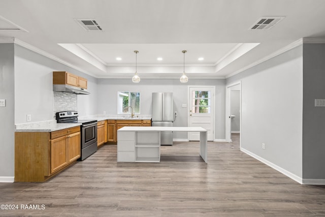 kitchen with light hardwood / wood-style floors, decorative light fixtures, appliances with stainless steel finishes, and sink