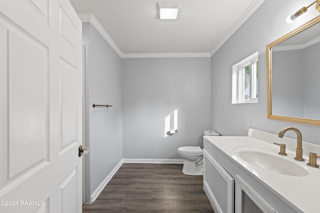 bathroom featuring ornamental molding, vanity, toilet, and wood-type flooring