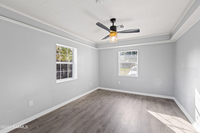 spare room featuring ornamental molding, hardwood / wood-style flooring, a wealth of natural light, and ceiling fan