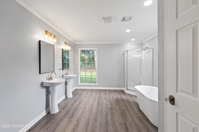 bathroom featuring ceiling fan, plus walk in shower, sink, ornamental molding, and hardwood / wood-style flooring