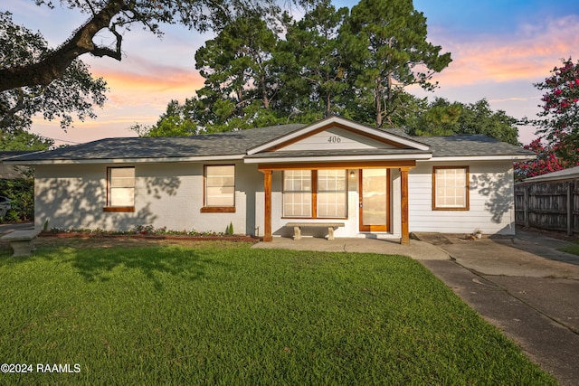 ranch-style house featuring a yard