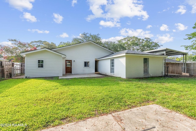 rear view of house featuring a yard and a patio area