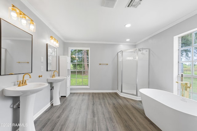 406 Orange Grove Ave, New Iberia, LA 70560 - bathroom with wood finished floors, a freestanding tub, a shower stall, crown molding, and baseboards