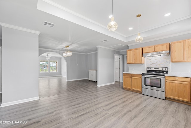 406 Orange Grove Ave, New Iberia, LA 70560 - kitchen with stainless steel range with electric cooktop, under cabinet range hood, arched walkways, light countertops, and ornamental molding