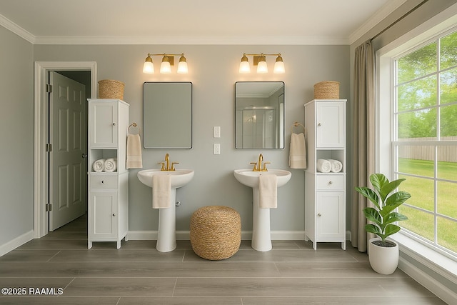406 Orange Grove Ave, New Iberia, LA 70560 - bathroom featuring wood finished floors, baseboards, ornamental molding, and a sink