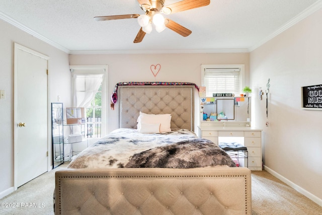 bedroom with ceiling fan, light colored carpet, a textured ceiling, and ornamental molding