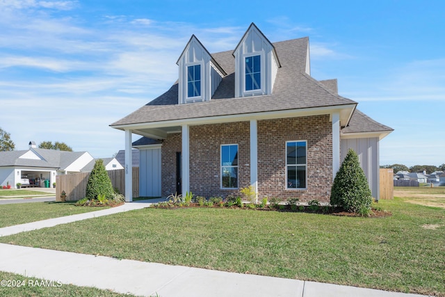 view of front of house with covered porch and a front lawn