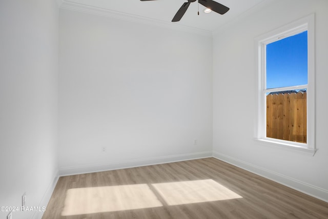 empty room with crown molding, ceiling fan, and light hardwood / wood-style floors