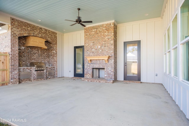 view of patio with exterior kitchen, a brick fireplace, area for grilling, and ceiling fan