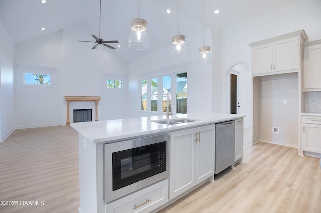 kitchen with white cabinetry, black microwave, dishwasher, and tasteful backsplash