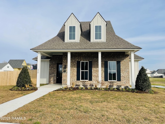 view of front facade featuring a front lawn and covered porch