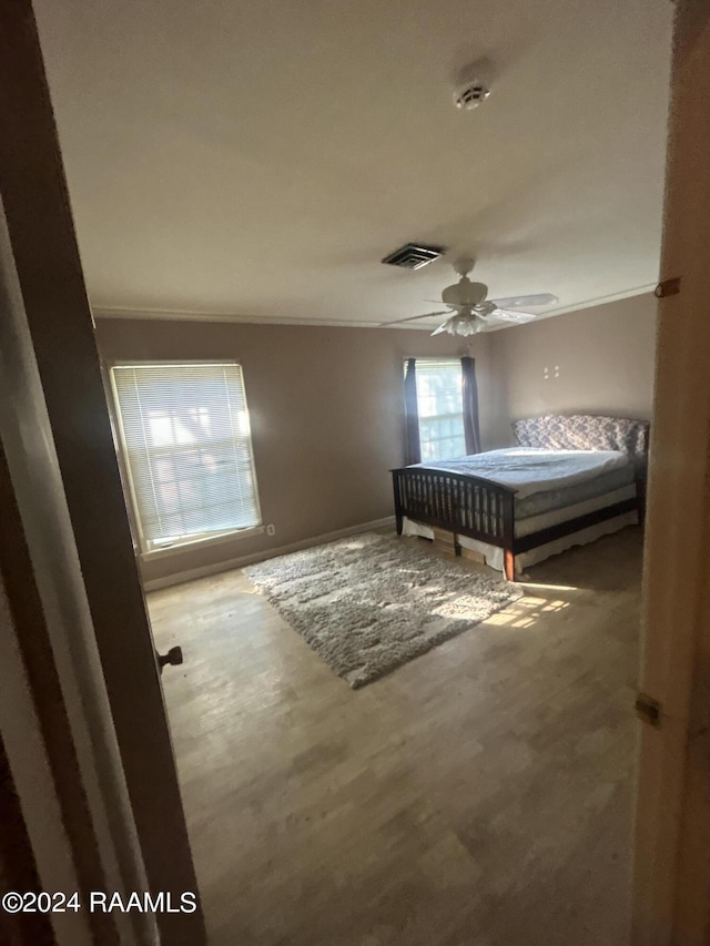 1519 Jasmine Dr, Opelousas, LA 70570 - bedroom with ceiling fan, baseboards, wood finished floors, and ornamental molding