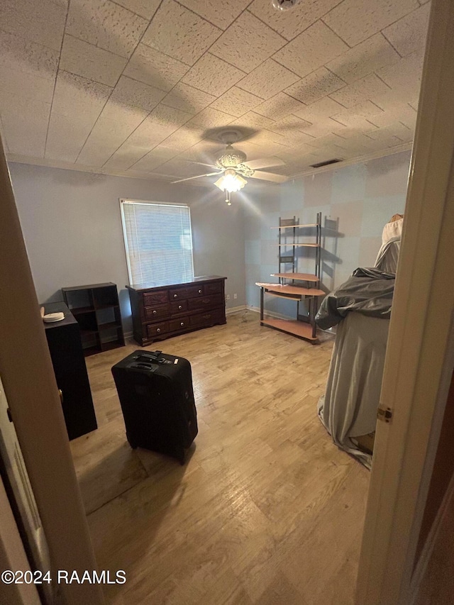 bedroom with light hardwood / wood-style flooring and ceiling fan